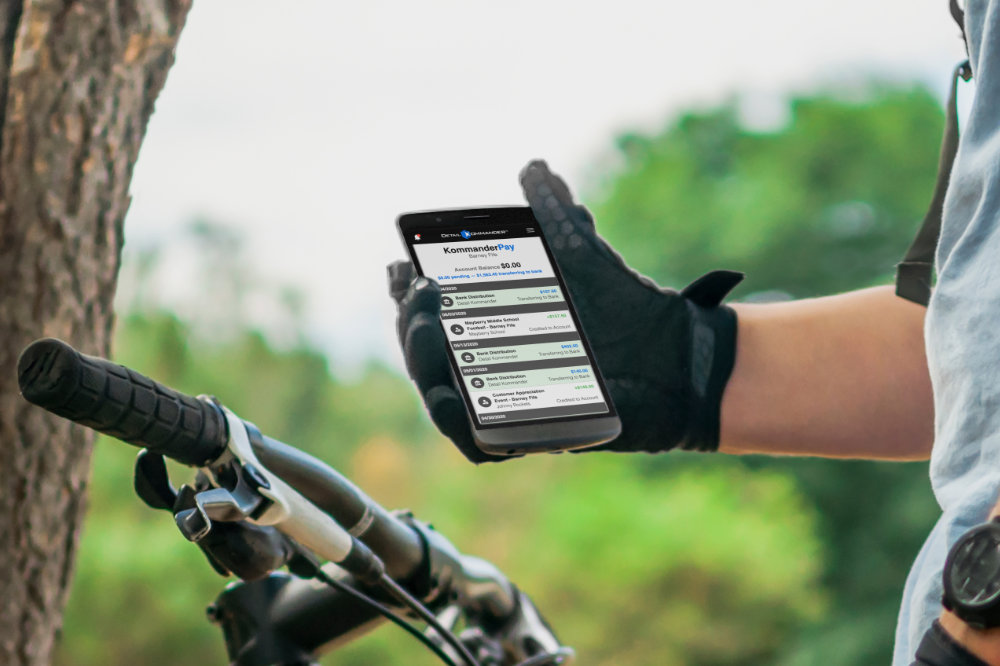 Kommander Pay interface on a bike rider's phone